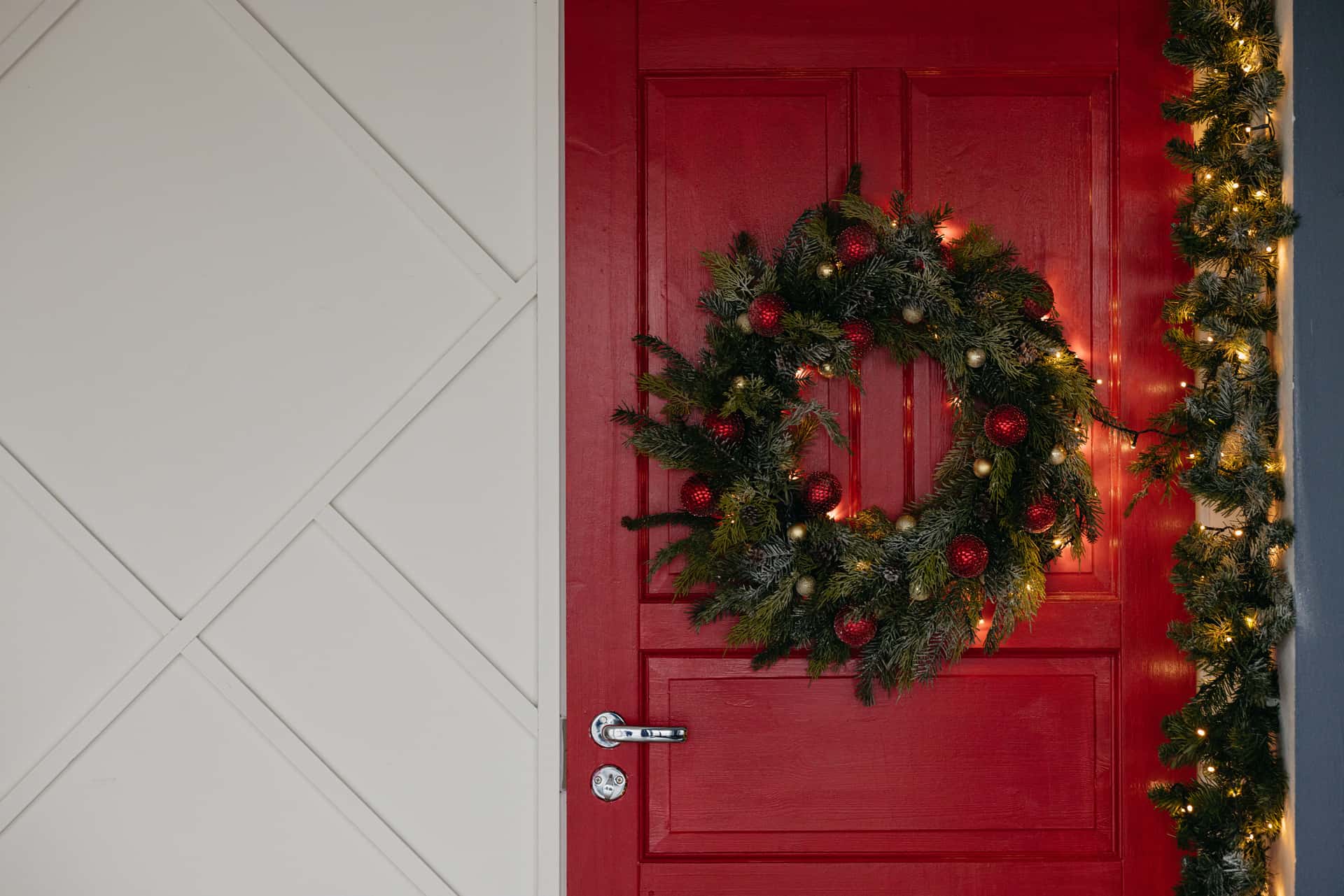 A closed white exterior door photographed from inside with cold daylight showing along its bottom edge